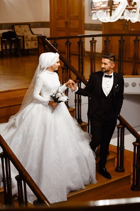 The bride and groom descending a grand staircase